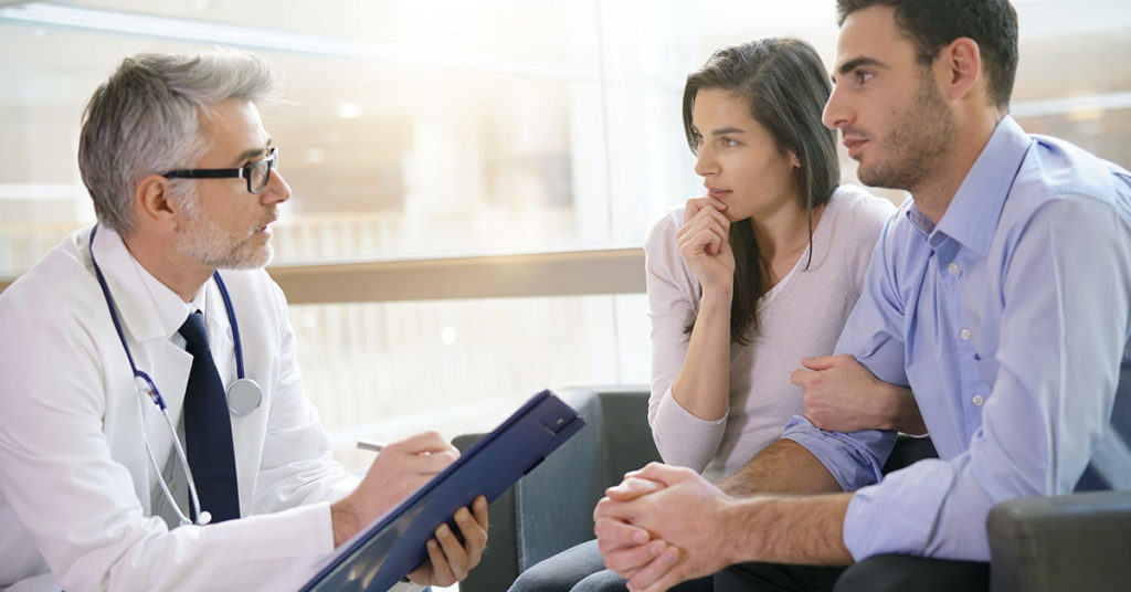 Couple meeting medical specialist at hospital